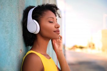 Girl listening music with headphones Smiling woman listening to soothing music with headphones